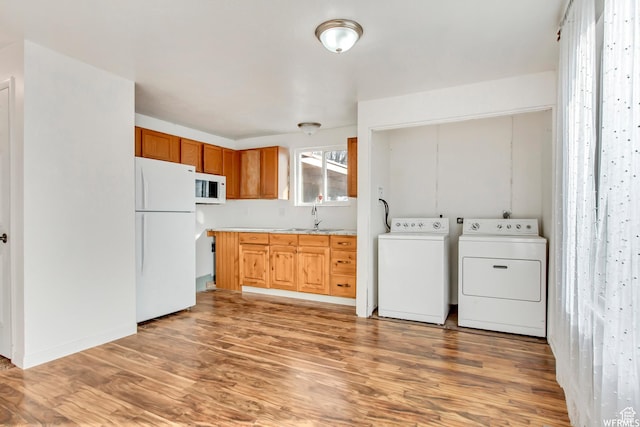 3185 S 4060 W, Salt Lake City, UT 84120 - laundry area featuring washing machine and dryer and light wood-style flooring