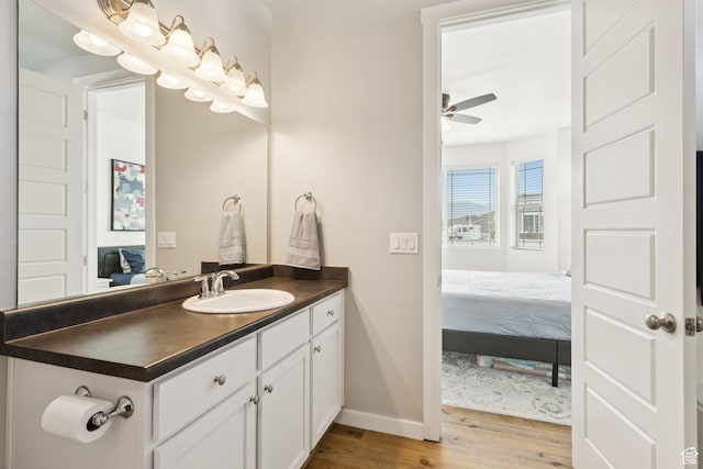 693 W Fireside Ln, Stansbury Park, UT 84074 - ensuite bathroom featuring wood finished floors, vanity, baseboards, and ceiling fan
