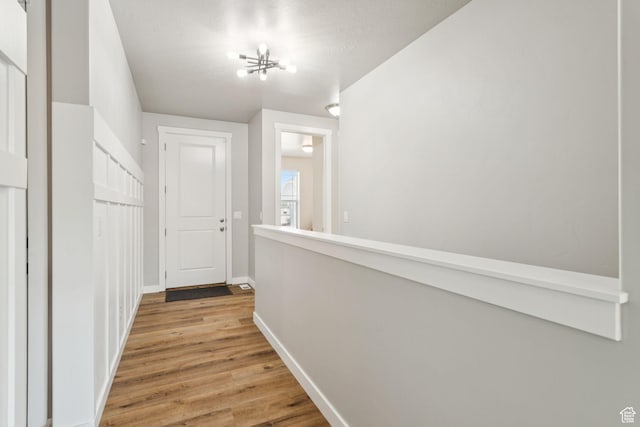 693 W Fireside Ln, Stansbury Park, UT 84074 - hallway featuring wood finished floors and baseboards