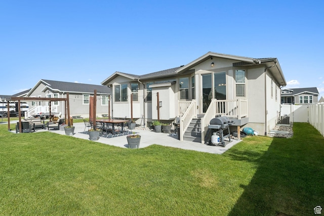 693 W Fireside Ln, Stansbury Park, UT 84074 - rear view of property featuring a patio area, stucco siding, and an outdoor hangout area