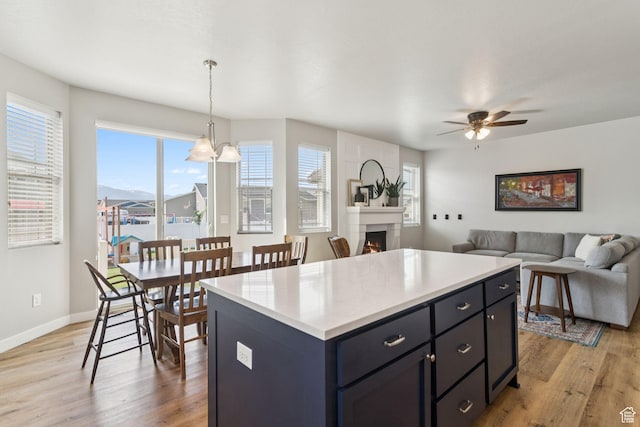 693 W Fireside Ln, Stansbury Park, UT 84074 - kitchen featuring light wood-type flooring, healthy amount of natural light, and light countertops