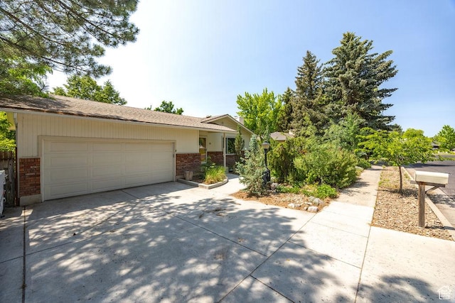 55 N 1300 E, Logan, UT 84321 - view of front of home featuring brick siding, concrete driveway, and a garage