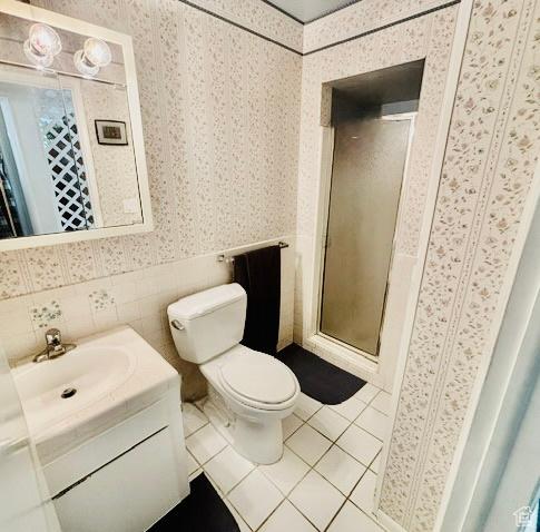 381 W 400 N Unit 12, Bountiful, UT 84010 - bathroom with wallpapered walls, vanity, tile patterned flooring, toilet, and a stall shower