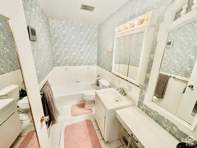 381 W 400 N Unit 12, Bountiful, UT 84010 - bathroom with wallpapered walls, toilet, a garden tub, vanity, and tile patterned floors
