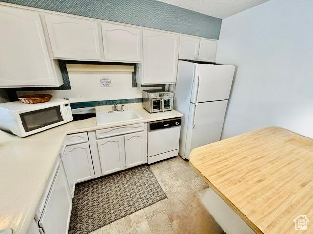 381 W 400 N Unit 12, Bountiful, UT 84010 - kitchen with white appliances, a sink, white cabinets, and light countertops