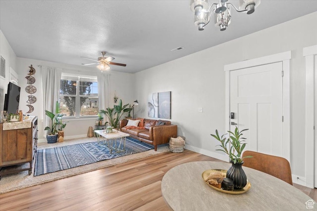 4192 W Mckellen Dr Unit B2, Herriman, UT 84096 - living area featuring wood finished floors, a chandelier, ceiling fan, and baseboards