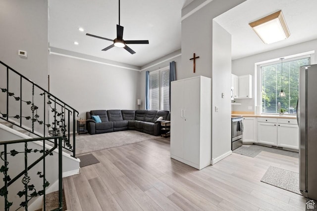 5747 S 2900 W, Roy, UT 84067 - living room featuring light wood-style floors, ceiling fan, stairs, and recessed lighting