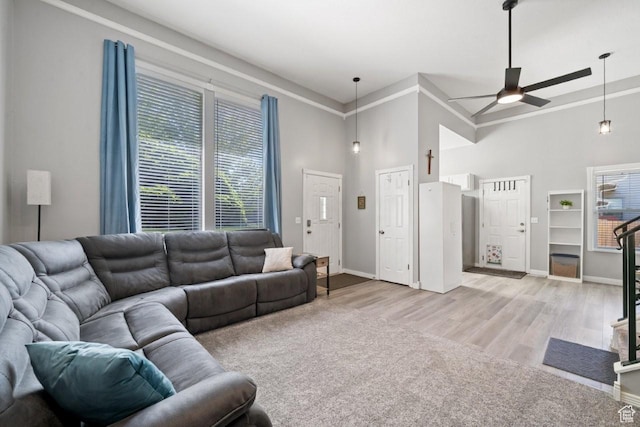 5747 S 2900 W, Roy, UT 84067 - living area featuring ceiling fan, baseboards, a towering ceiling, light wood-style floors, and crown molding