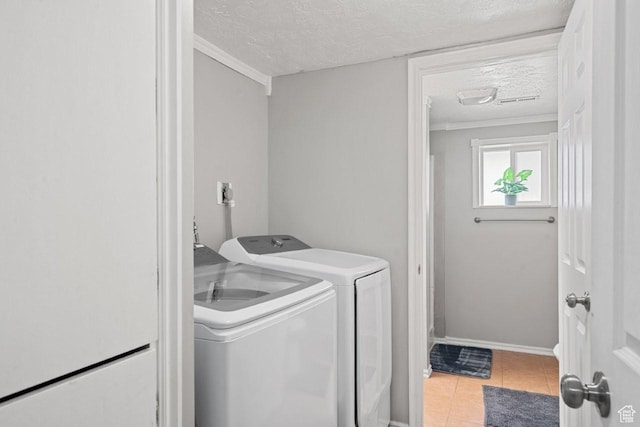 5747 S 2900 W, Roy, UT 84067 - laundry area with separate washer and dryer, a textured ceiling, light tile patterned floors, crown molding, and baseboards