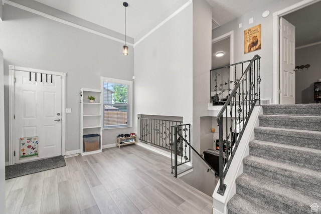 5747 S 2900 W, Roy, UT 84067 - foyer with a high ceiling, wood finished floors, baseboards, crown molding, and stairs