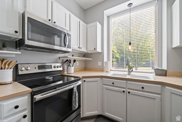 5747 S 2900 W, Roy, UT 84067 - kitchen with appliances with stainless steel finishes, a sink, white cabinetry, and light countertops