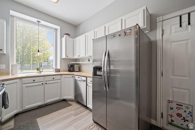 5747 S 2900 W, Roy, UT 84067 - kitchen featuring appliances with stainless steel finishes, light wood-type flooring, and white cabinets