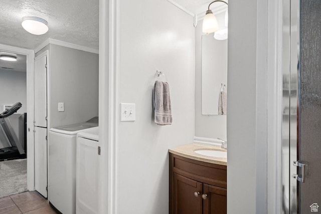 5747 S 2900 W, Roy, UT 84067 - bathroom featuring washing machine and dryer, vanity, crown molding, a textured ceiling, and tile patterned floors