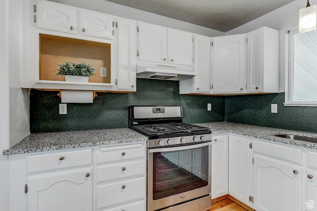4799 S 3900 W, Roy, UT 84067 - kitchen featuring stainless steel range with gas cooktop, under cabinet range hood, white cabinetry, and a textured ceiling
