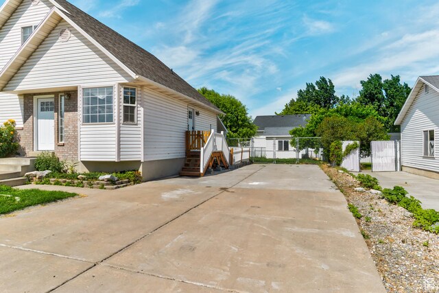 4799 S 3900 W, Roy, UT 84067 - view of front of home with concrete driveway, roof with shingles, and a gate