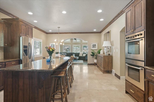 4280 S Scenic Cir E, Bountiful, UT 84010 - kitchen with appliances with stainless steel finishes, open floor plan, crown molding, a chandelier, and dark stone countertops