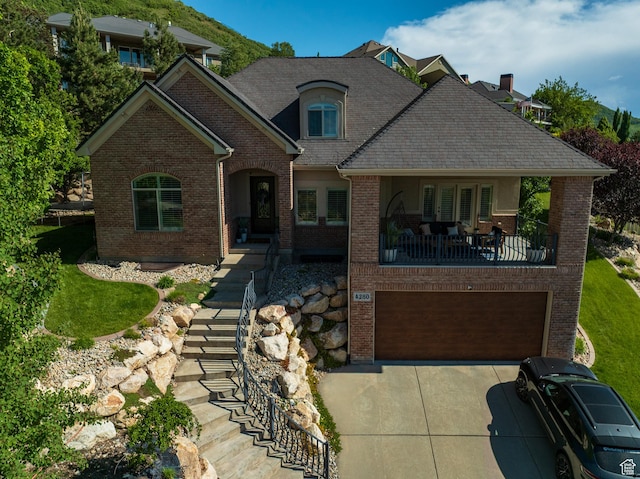 4280 S Scenic Cir E, Bountiful, UT 84010 - view of front of house with brick siding, driveway, and an attached garage