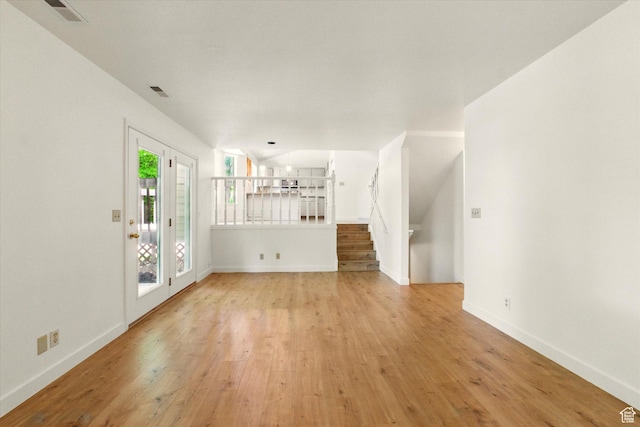 1553 N 1525 E, Logan, UT 84341 - unfurnished living room featuring light wood finished floors, stairway, and baseboards