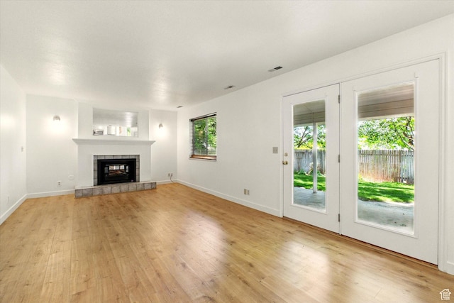 1553 N 1525 E, Logan, UT 84341 - unfurnished living room featuring light wood finished floors, a fireplace, and baseboards