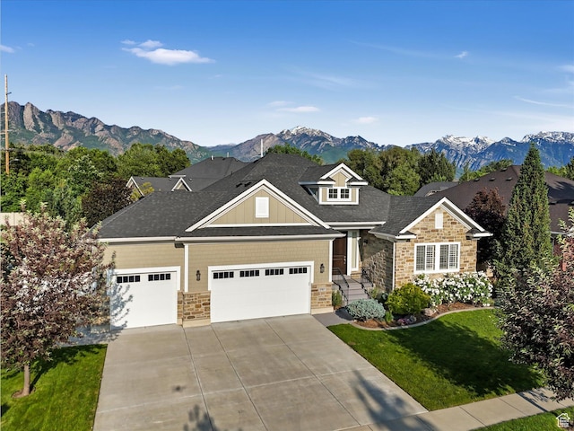 5767 S Erekson Ln, Murray, UT 84107 - craftsman-style home featuring stone siding, concrete driveway, a garage, a front yard, and a mountain view