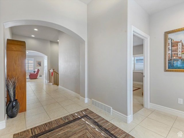 5767 S Erekson Ln, Murray, UT 84107 - corridor with light tile patterned floors, plenty of natural light, baseboards, arched walkways, and recessed lighting