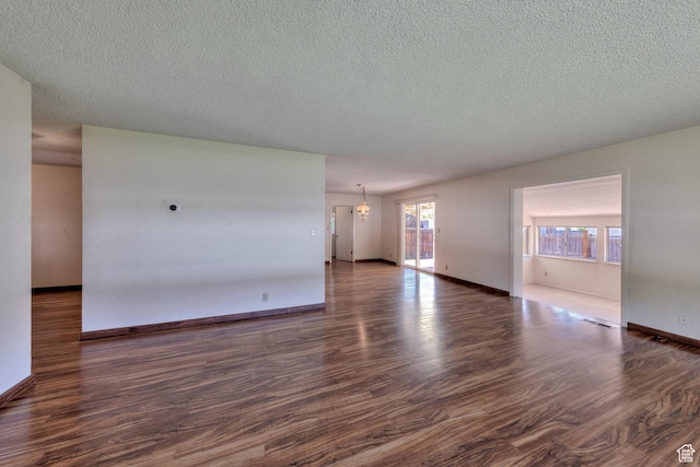 630 N 500 W, Moab, UT 84532 - unfurnished living room with dark wood-style flooring, a textured ceiling, and baseboards