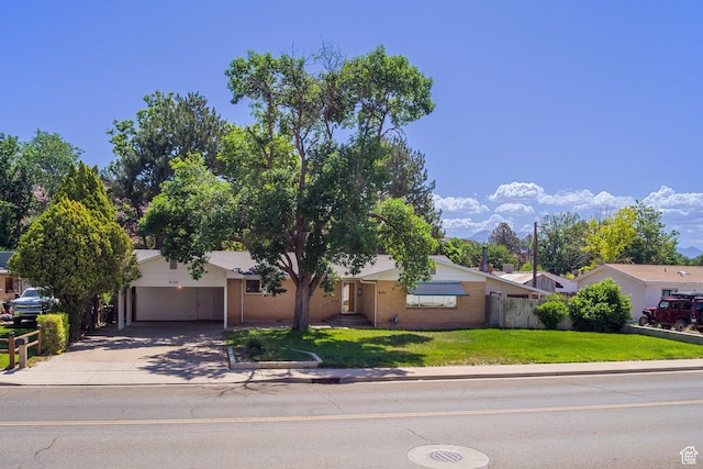 630 N 500 W, Moab, UT 84532 - view of front of house with concrete driveway, an attached garage, and brick siding
