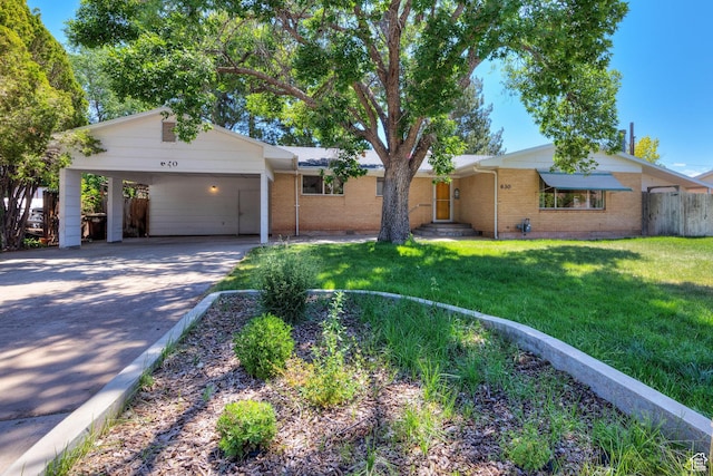 630 N 500 W, Moab, UT 84532 - ranch-style home featuring driveway, brick siding, and a carport