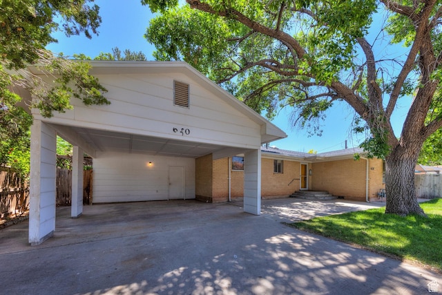 630 N 500 W, Moab, UT 84532 - view of front of house with a carport, brick siding, and concrete driveway