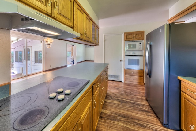 630 N 500 W, Moab, UT 84532 - kitchen featuring white appliances, under cabinet range hood, brown cabinets, dark wood-style flooring, and a chandelier