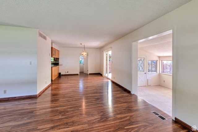 630 N 500 W, Moab, UT 84532 - unfurnished living room with dark wood-style floors, a textured ceiling, and baseboards
