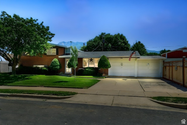 5226 S 200 W, Washington Terrace, UT 84405 - view of front facade featuring brick siding, a mountain view, an attached garage, and driveway