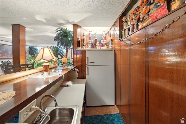 5226 S 200 W, Washington Terrace, UT 84405 - kitchen with freestanding refrigerator, a sink, and brown cabinetry