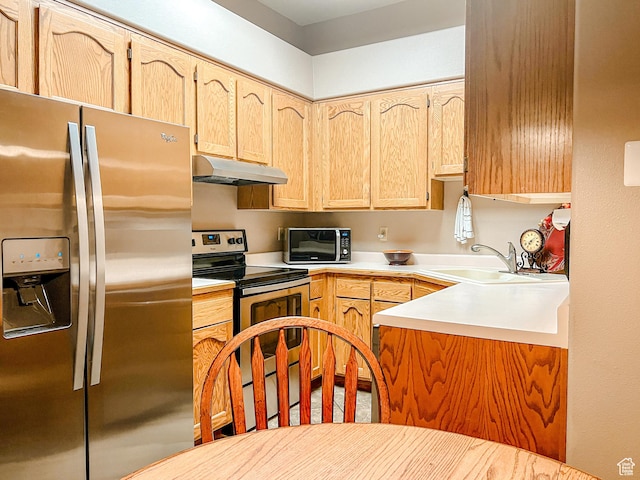2051 W Canyon View Dr S, St George, UT 84770 - kitchen featuring stainless steel appliances, under cabinet range hood, a sink, light brown cabinetry, and light countertops