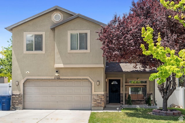 1730 W Joust Ct, Salt Lake City, UT 84116 - view of front of house featuring stone siding, driveway, a garage, and stucco siding
