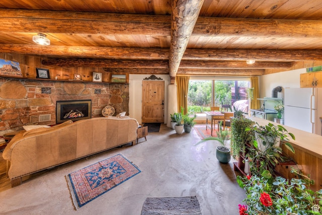 7020 E Creekside Ln, Castle Valley, UT 84532 - living room with wooden ceiling with exposed beams, unfinished concrete floors, and a fireplace