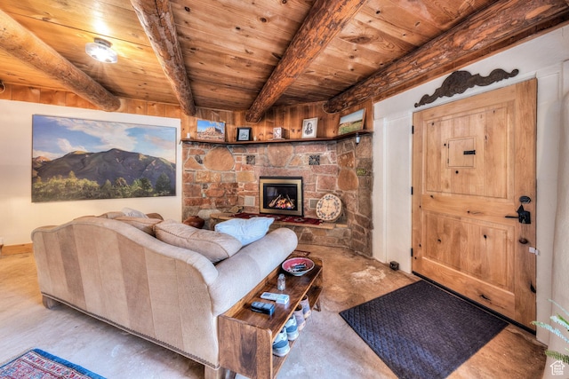 7020 E Creekside Ln, Castle Valley, UT 84532 - living area with wooden ceiling with exposed beams, a stone fireplace, and baseboards