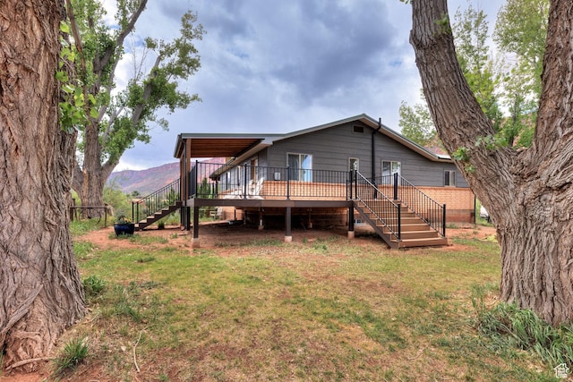 7020 E Creekside Ln, Castle Valley, UT 84532 - back of property with stairway, a deck with mountain view, and a yard