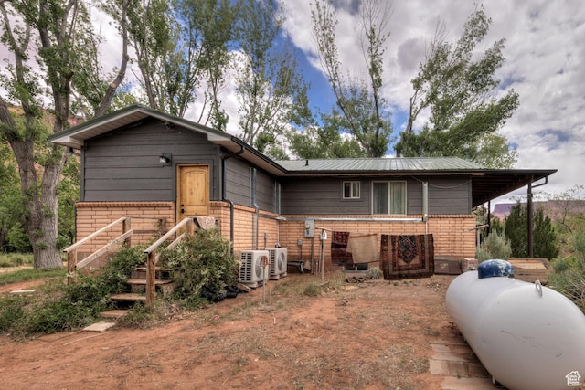 7020 E Creekside Ln, Castle Valley, UT 84532 - view of front facade with brick siding and ac unit