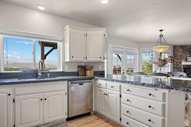 663 N 880 E, Springville, UT 84663 - kitchen featuring stainless steel dishwasher, a sink, a peninsula, white cabinets, and dark stone counters