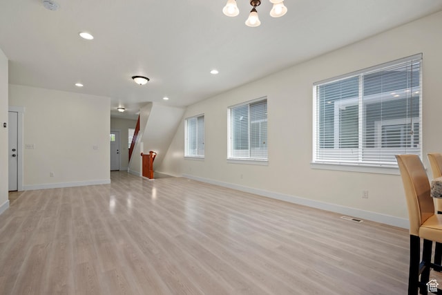 11066 S Becks Ln, South Jordan, UT 84095 - unfurnished living room with light wood-style floors, baseboards, recessed lighting, and a chandelier