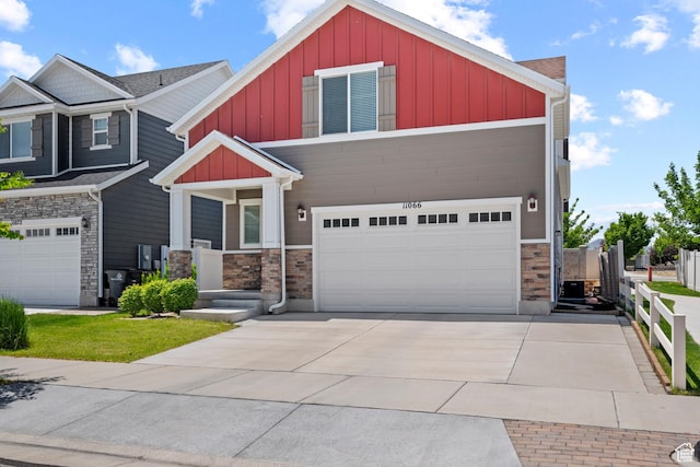 11066 S Becks Ln, South Jordan, UT 84095 - craftsman inspired home with board and batten siding, stone siding, an attached garage, concrete driveway, and cooling unit