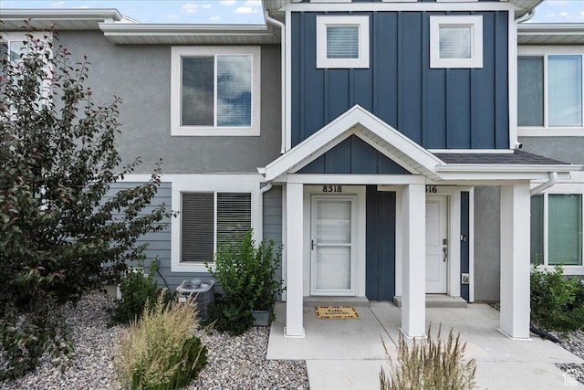 8518 W Cordero Dr, Magna, UT 84044 - view of exterior entry featuring board and batten siding and central air condition unit