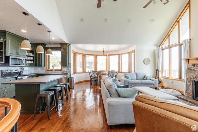 761 S Lakeview Dr, Garden City, UT 84028 - living room featuring ceiling fan, baseboards, healthy amount of natural light, and high vaulted ceiling