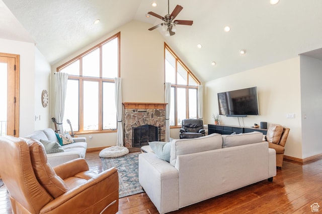 761 S Lakeview Dr, Garden City, UT 84028 - living area with a fireplace, ceiling fan, high vaulted ceiling, hardwood / wood-style floors, and baseboards