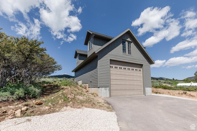 761 S Lakeview Dr, Garden City, UT 84028 - view of side of home with a garage and asphalt driveway