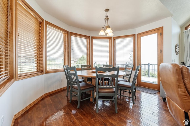 761 S Lakeview Dr, Garden City, UT 84028 - dining area with a chandelier, plenty of natural light, dark wood finished floors, and baseboards
