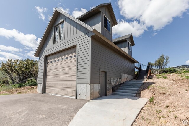 761 S Lakeview Dr, Garden City, UT 84028 - view of side of property with driveway, board and batten siding, and stairs