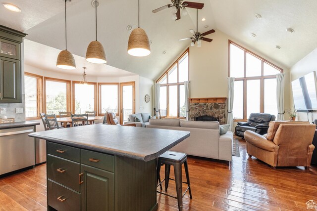 761 S Lakeview Dr, Garden City, UT 84028 - kitchen featuring stainless steel dishwasher, high vaulted ceiling, a center island, a kitchen breakfast bar, and a ceiling fan