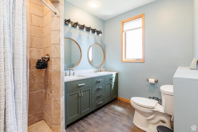 761 S Lakeview Dr, Garden City, UT 84028 - full bathroom with toilet, double vanity, tiled shower, and wood tiled floors